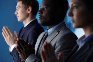 Group of business partners praying for their new project