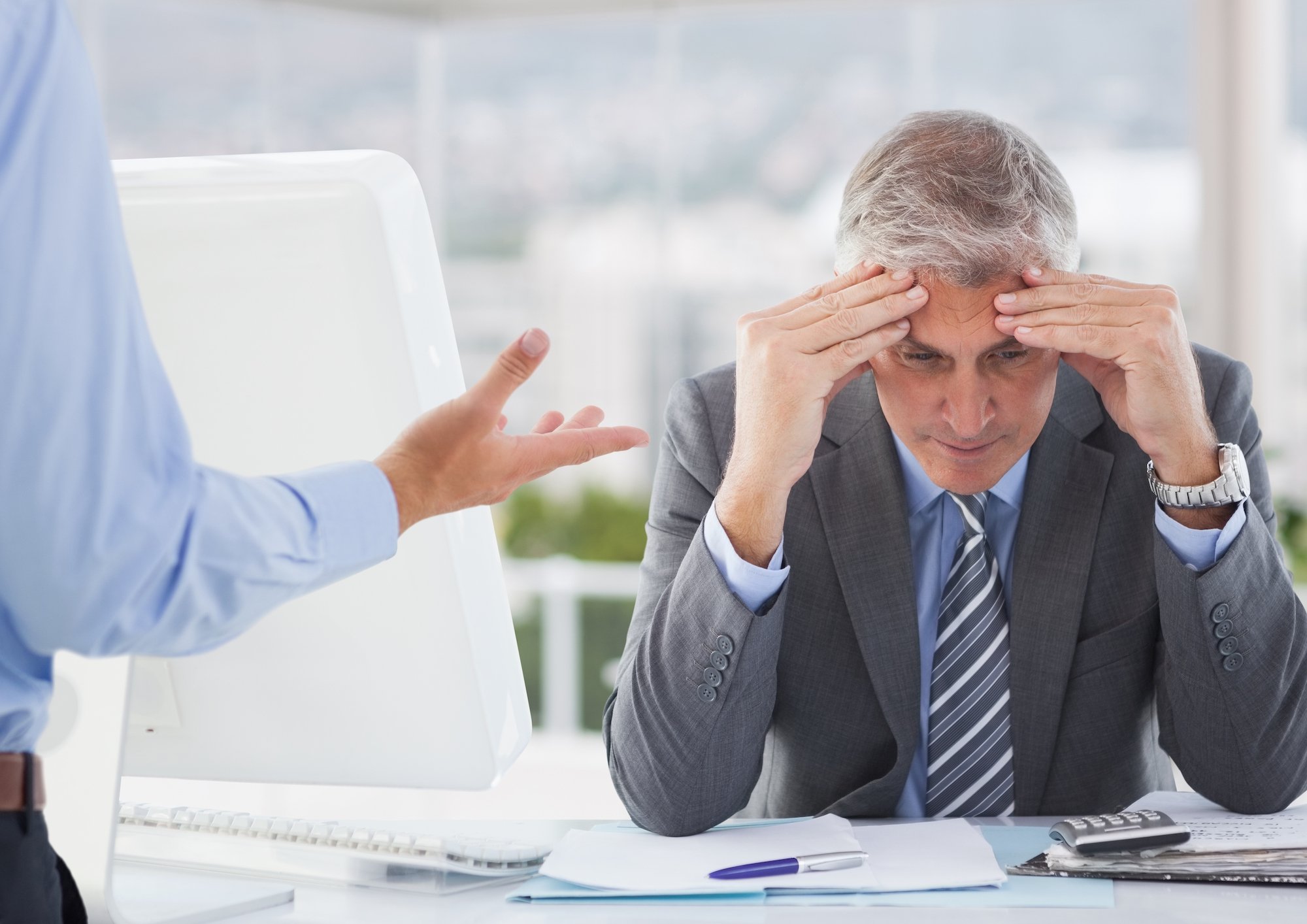 wesfarmers-shares-wes-ceo-Frustrated businessman sitting with hands on forehead