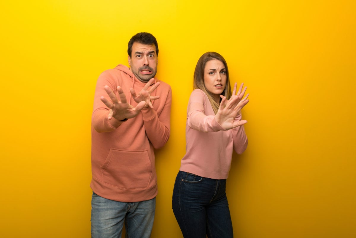 asx 200. image shows couple look scared or fearful at the camera